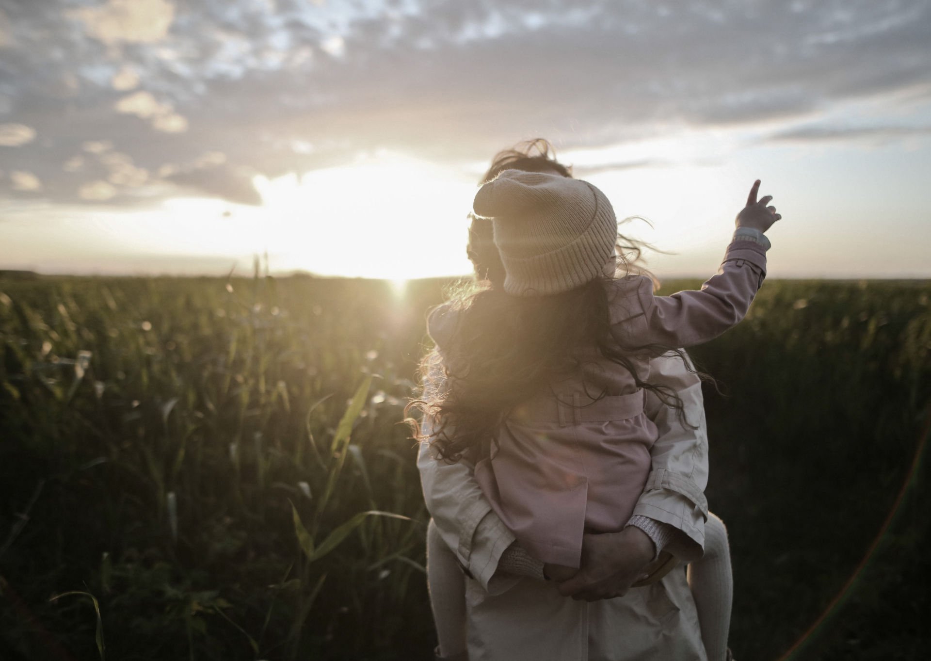 child-and-mother-looking-at-sunrise